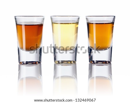 Three kinds of alcoholic drinks in shot glasses Royalty-Free Stock Photo #132469067
