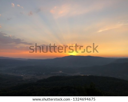 The twilightgloden orange sky in the evening when the sunset at Phu Taopong, the unseen destination mountain of Dansai district, Loei province, Thailand. 