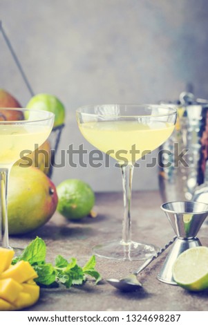 Margarita Mango alcoholic cocktail in a glass on stone background.