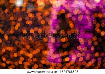 Abstract colorful blur bokeh fairy light festival, city street light defocused at night, dark background.
