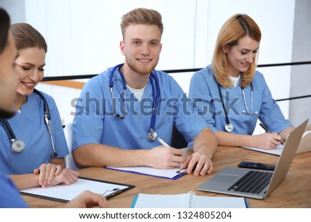 Medical students in uniforms studying at university