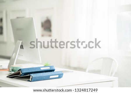 Minimal work space desk, office desk with modern computer and note book on white background view with copy space 