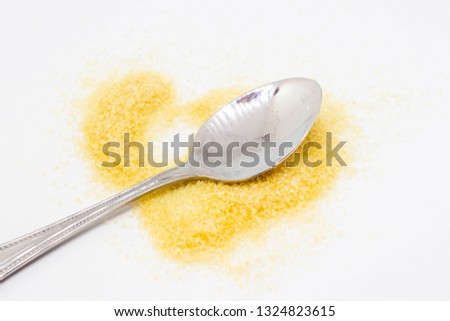 
Spoon and brown sugar isolated on white background.