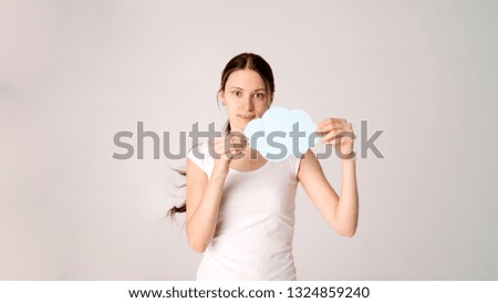 woman holding blank speech bubble on white background