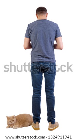Back view of a man with a cat. Rear view people collection.  backside view of person.  Isolated over white background. Young guy with a red cat.