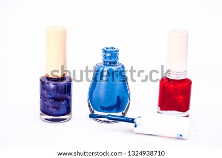 Blue,purple and red colored three nail polish bottle isolated on white.