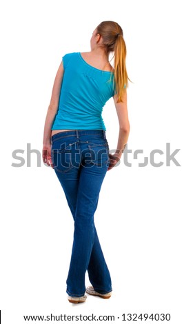 back view of standing young beautiful  blonde woman girl looks in a relaxed position in  side. girl  watching. Rear view people collection.  backside view of person.  Isolated over white background.
