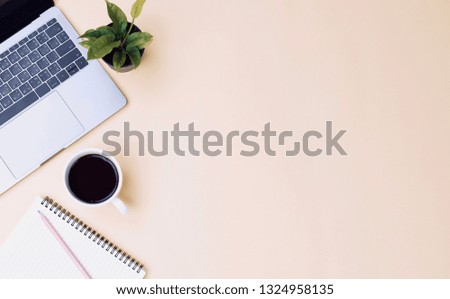 office workspace yellow desk table with laptop, coffee, mobile, notebook, plant. flat lay