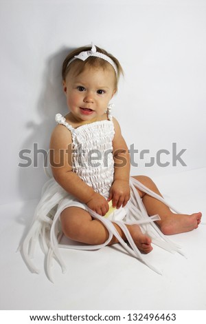 beautiful little girl in the studio on a gray background