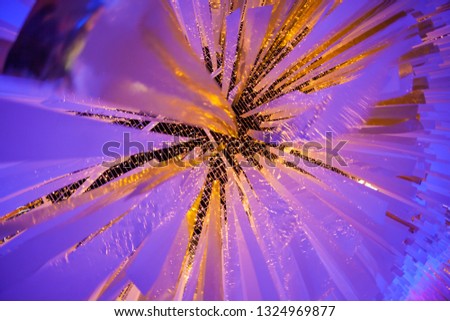Abstract background of white strip plastics hanging with small spot colourful lighting source.