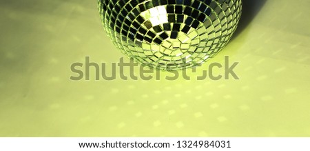 beautiful disco ball on yellow background isolated.