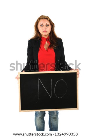 Serious young teacher holding a blackboard with the word no on it against a white background