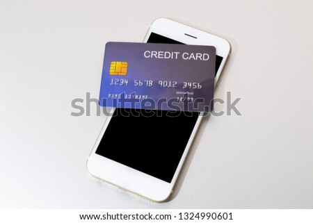 credit card put on mobile phone preparing to pay white background