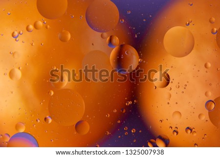 abstract background oil drops on water macro orange