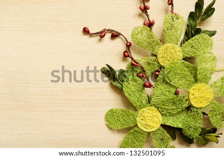 Light wooden background with the composition of artificial flowers