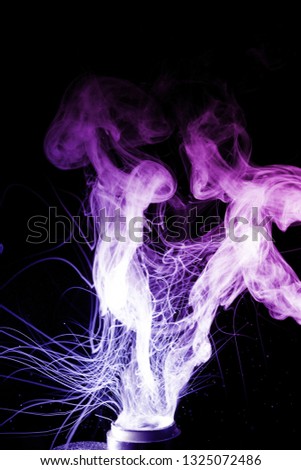 Vape clouds splash isolated on black background. Two colours fog is blue and purple. Stock color smoke photo with spray boiling glycerine.