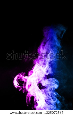 Vape clouds splash with two colours fog is blue and purple colour. Low light photo. Stock isolated on black background color smoke with spray boiling glycerine lines.