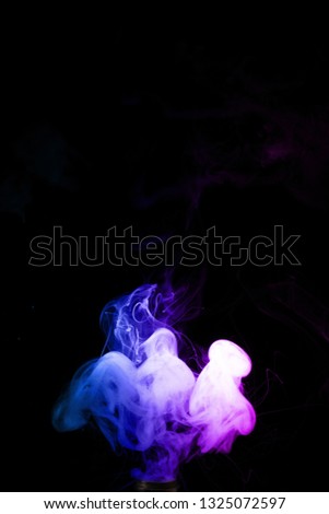 Colored clouds of vape smoke. A lot of colour and glicerine clouds, red and blue colours. Stock photo isolated on black background with boling spray of vaping liquid. Vape culture and no smoking