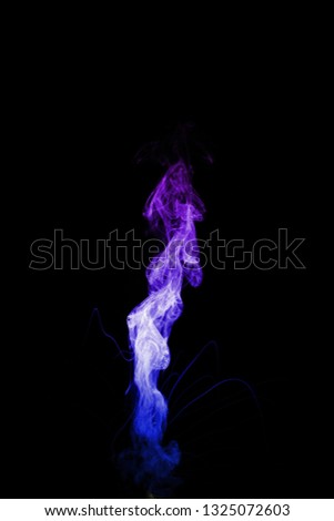 Dual colour vape steam column with spray boiling liquid. Blue and purple colour smoke. Stock photo isolated on black background. 