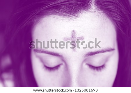 woman with cross on forehead in observance of Ash Wednesday