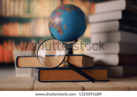 Textbooks,  globe and pencils on a wooden background. Educational background 