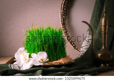 Novruz still life with semeni sabzi wheatgrass , silk national scarf, eastern musical instrument and orchids. Spring equinox in March celebration, copy space 