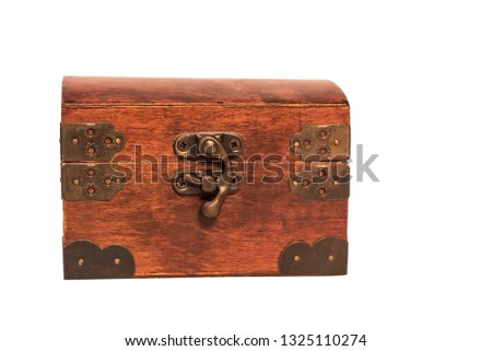 Closed wooden vintage box for storing jewelry on a white background, small ornamental box or chest for holding jewels, letters, or other valuable objects. Isolated