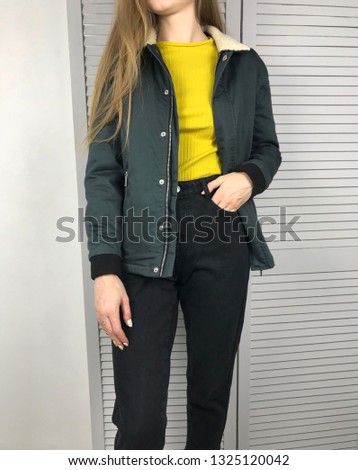 Girl in green jacket on a white background