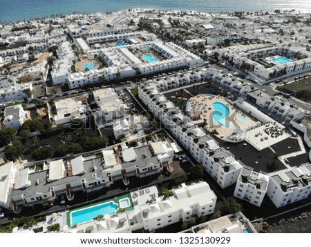 Aerial photo of the beautiful Lanzarote in Spain one of the Canary Islands, showing hotels and homes with the coastal area in the background.