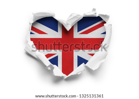 Heart shaped hole torn through paper, showing satin texture of flag of Great Britain. Isolated on white background