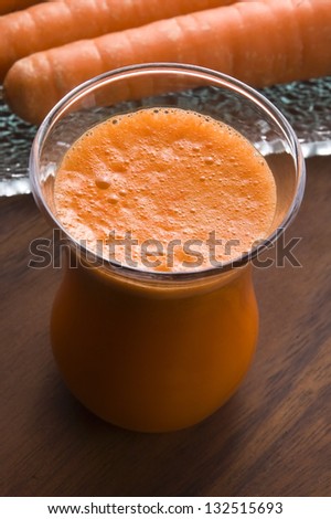 carrot juice on a wooden background