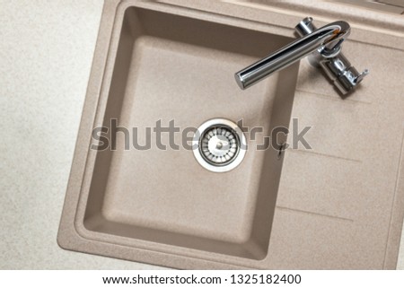 Granite kitchen sink with stainless two-handle faucet. Top view with copy space Royalty-Free Stock Photo #1325182400