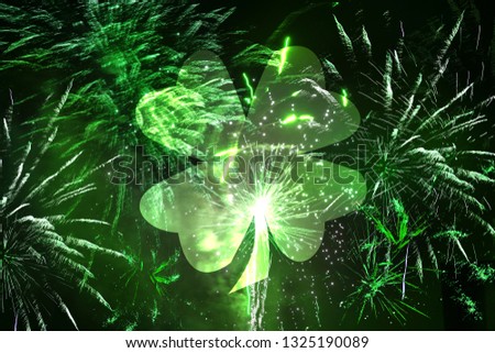 A shamrock leaf with beautiful green fireworks in the background - St. Patrick's Day concept
