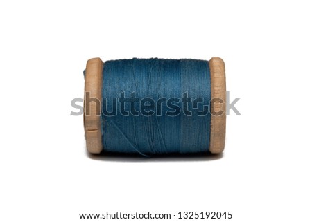 Wooden coil with sewing thread on a white background