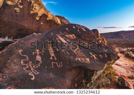 Ancestral Puebloan, or Anasazi petroglyphs of human figures in the Santa Clara River Reserve near Ivins and Saint George, Utah, United States. Royalty-Free Stock Photo #1325234612