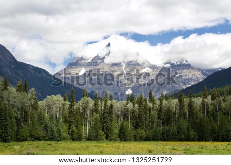 Dramatic mountains on a sunny day with blue sky and green trees