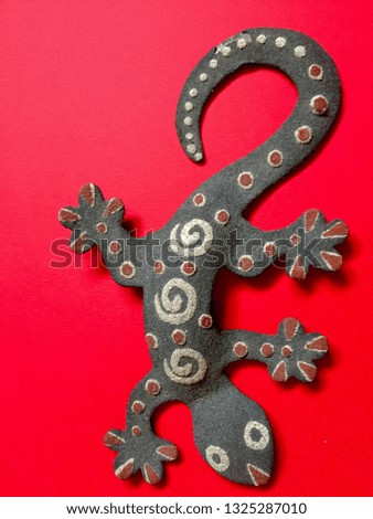 gecko on a red background