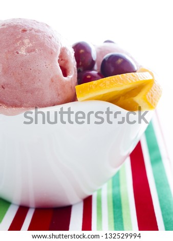Gourmet sweet orange and cranberry gelato on white background.