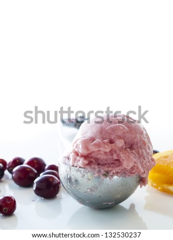 Gourmet sweet orange and cranberry gelato on white background.