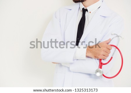 Male doctor holding stethoscope on white background. Medical and healthcare concept.