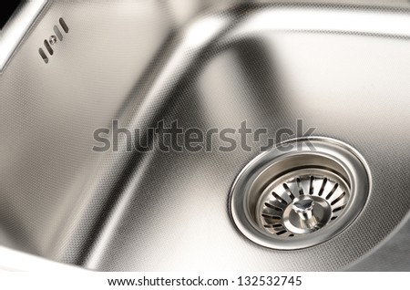 Stainless steel sink with drain. Closeup. Royalty-Free Stock Photo #132532745
