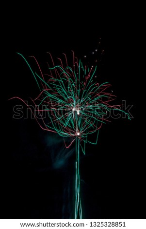 populous festive multi colour fireworks outside the city in the summer camp on isolated background of the night black sky