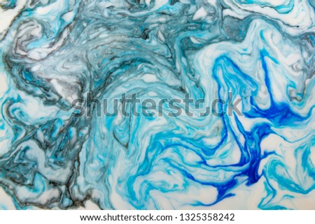 Abstract beautiful blue marble pattern with black color.The Eastern style of Ebru painting on water with acrylic paints swirls.A stylish mix of colors,natural luxury.