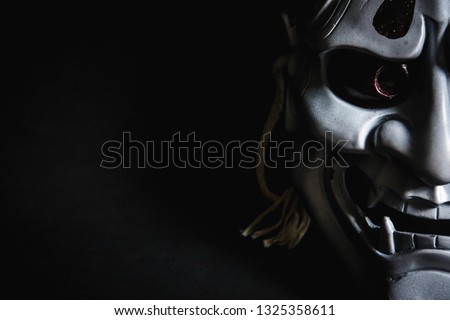 Japanese oni mask or giant mask, used to decorate handmade from original to make it look dark and art, with half of the face then look more scary