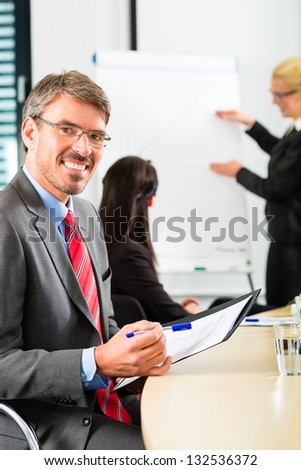 Business - businesspeople have a meeting with presentation in office, they negotiate a contract - Portrait of a businessman