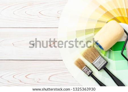 sample colors catalogue pantone or colour swatches book with paint roller brush