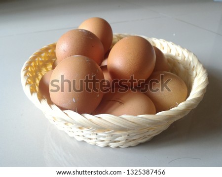 A picture of eggs in a basket isolated on white background