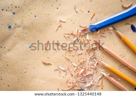 Manually sharpened pencils with office cutter on workshop table, with text space