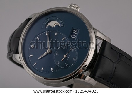 Men's watch with black leather strap,blue dial,gray clockwise,Roman numerals,chronograph and stopwatch isolated on white background.