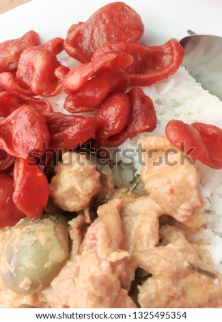 Red pork curry (Panang) and pork sausage with rice in white, Thai food